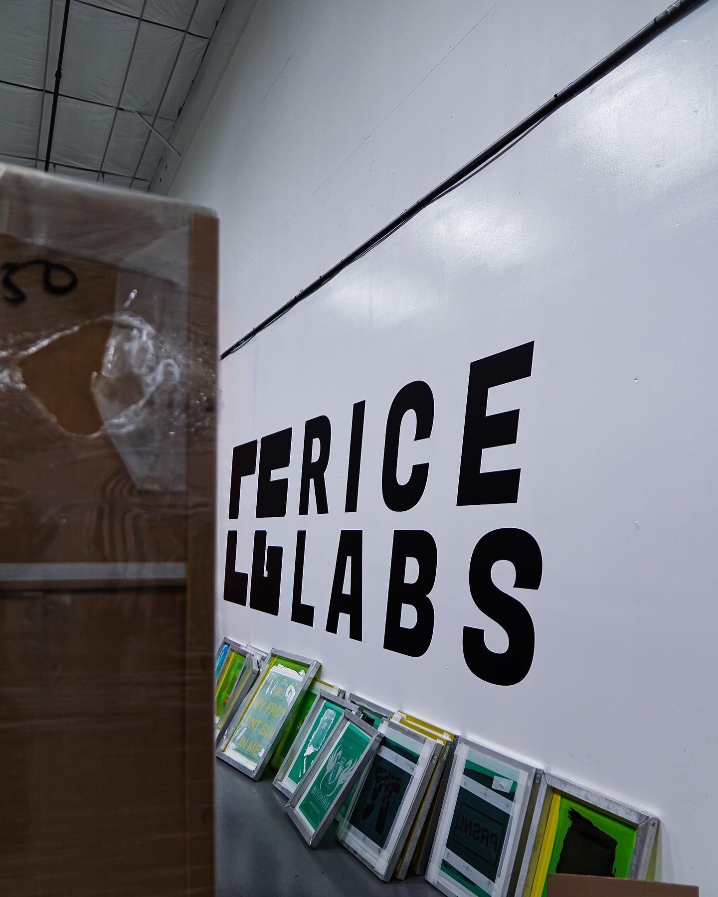 Exposed screens lined against the RICE LABS wall mark